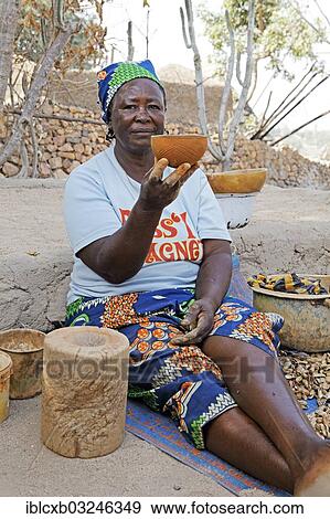 Stock Photo - "Woman of the Kapsiki ethnic group manufacturing bowls made of clay, cow dung and goat dung, Rhumsiki, Far North, Cameroon, Africa". Fotosearch