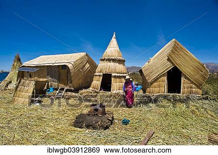 "Woman of the Uro Indians in front of typical reed huts, traditional clay oven in the foreground, floating islands made of totora reeds, Lake Titicaca, southern Peru, Peru, South America" View Large Photo Image Stock Photo - "Woman of the Uro Indians in front of typical reed huts, traditional clay oven in the foreground, floating islands made of totora reeds, Lake Titicaca, southern Peru, Peru, South America". Fotosearch