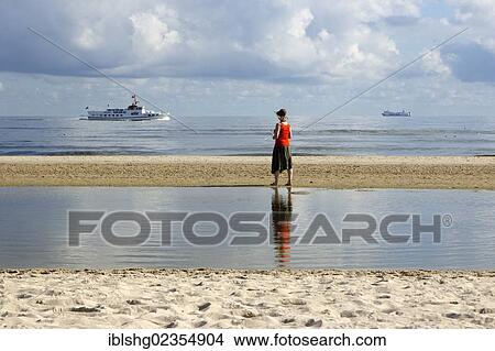 Picture - "Woman on a beach, Heringsdorf, Usedom Island, Mecklenburg-Western Pomerania, Germany, Europe". Fotosearch