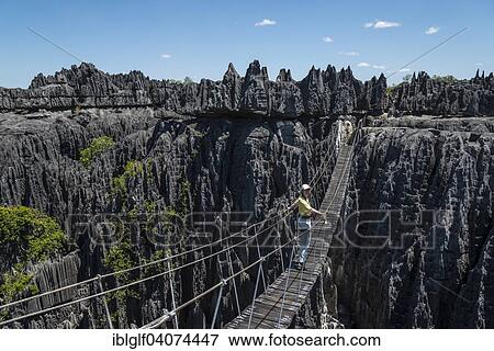 "Woman on suspension bridge in the National Park Tsingy du Bemaraha, UNESCO World Heritage Site, Mahajanga, Madagascar, Africa" View Large Photo Image Stock Photo - "Woman on suspension bridge in the National Park Tsingy du Bemaraha, UNESCO World Heritage Site, Mahajanga, Madagascar, Africa". Fotosearch