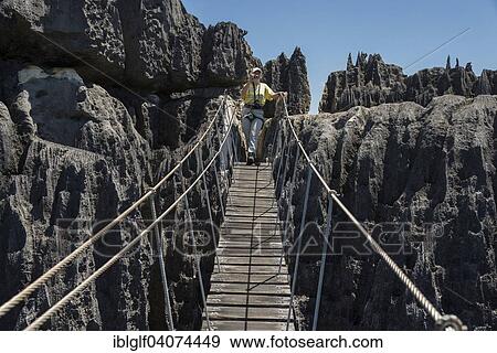"Woman on suspension bridge in the National Park Tsingy du Bemaraha, UNESCO World Heritage Site, Mahajanga, Madagascar, Africa" View Large Photo Image Stock Photo - "Woman on suspension bridge in the National Park Tsingy du Bemaraha, UNESCO World Heritage Site, Mahajanga, Madagascar, Africa". Fotosearch