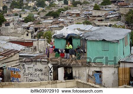 "Woman on the balcony of her green-painted shack, Fort National slum, Port-au-Prince, Haiti, North America" View Large Photo Image Stock Image - "Woman on the balcony of her green-painted shack, Fort National slum, Port-au-Prince, Haiti, North America". Fotosearch