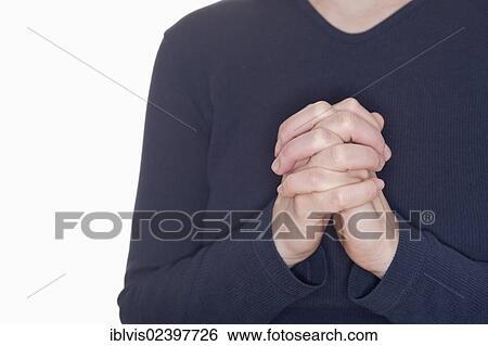Woman praying with her hands clasped View Large Photo Image Stock Photograph - Woman praying with her hands clasped. Fotosearch