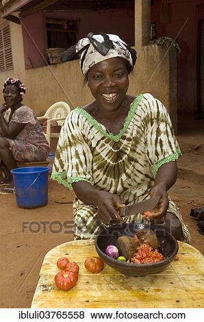 "Woman preparing a traditional tomato dish, Kuluedor, Ghana, Africa" View Large Photo Image Stock Photo - "Woman preparing a traditional tomato dish, Kuluedor, Ghana, Africa". Fotosearch