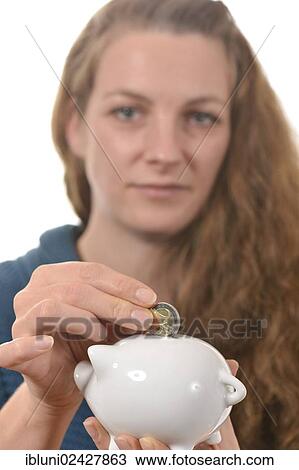 Woman putting a 2 euro coin in a piggy bank View Large Photo Image Stock Image - Woman putting a 2 euro coin in a piggy bank. Fotosearch
