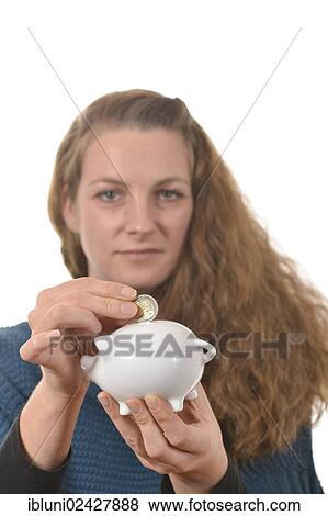 Woman putting a 2 euro coin in a piggy bank View Large Photo Image Stock Photo - Woman putting a 2 euro coin in a piggy bank. Fotosearch