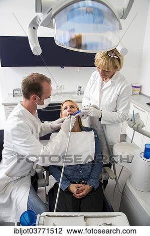 Stock Image - "Woman receiving treatment at the dentist, Germany, Europe". Fotosearch
