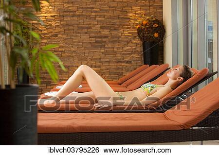 Stock Photograph - Woman relaxing in the relaxation area of a spa complex. Fotosearch