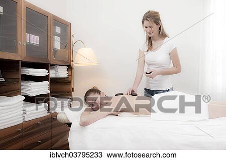 Woman relaxing with a massage View Large Photo Image Stock Image - Woman relaxing with a massage. Fotosearch