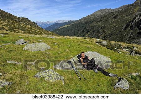 "Woman resting after a mountain hike, Fotschertal valley with view of the Nordkette range, Tyrol, Austria, Europe" View Large Photo Image Stock Image - "Woman resting after a mountain hike, Fotschertal valley with view of the Nordkette range, Tyrol, Austria, Europe". Fotosearch