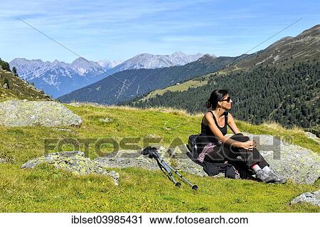"Woman resting after a mountain hike, Fotschertal valley with view of the Nordkette range, Tyrol, Austria, Europe" View Large Photo Image Stock Image - "Woman resting after a mountain hike, Fotschertal valley with view of the Nordkette range, Tyrol, Austria, Europe". Fotosearch
