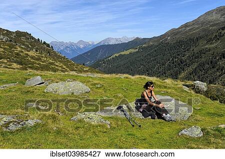 "Woman resting after a mountain hike, Fotschertal valley with view of the Nordkette range, Tyrol, Austria, Europe" View Large Photo Image Stock Photo - "Woman resting after a mountain hike, Fotschertal valley with view of the Nordkette range, Tyrol, Austria, Europe". Fotosearch