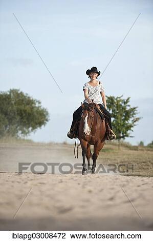 Stock Image - "Woman riding a trotting Quarter Horse, Germany, Europe". Fotosearch