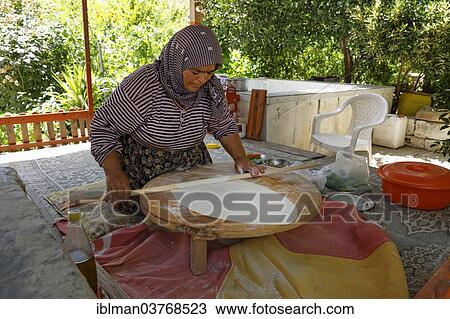 Stock Image - "Woman rolling dough for Goezleme flatbread, Anatolian cuisine, Antalya Province, Turkey, Asia". Fotosearch