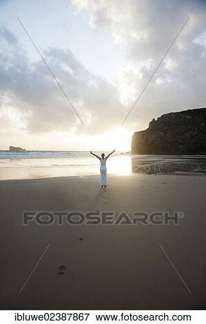Woman running along a beach at sunset View Large Photo Image Stock Photo - Woman running along a beach at sunset. Fotosearch