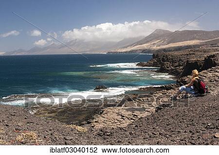 "Woman, sea, coast and rocks, Cofete, Morro Jable, Naturpark Jandia, Fuerteventura, Canary Islands, Spain, Europe" View Large Photo Image Stock Image - "Woman, sea, coast and rocks, Cofete, Morro Jable, Naturpark Jandia, Fuerteventura, Canary Islands, Spain, Europe". Fotosearch