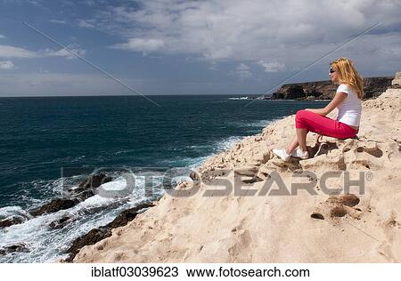 "Woman, sea, coast and rocks, Los Molinos, Fuerteventura, Canary Islands, Spain, Europe" View Large Photo Image Stock Image - "Woman, sea, coast and rocks, Los Molinos, Fuerteventura, Canary Islands, Spain, Europe". Fotosearch
