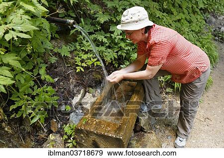 "Woman seeking refreshment at a fountain, Groppensteinschlucht, Obervellach, Spittal an der Drau, Carinthia, Austria, Europe" View Large Photo Image Stock Photo - "Woman seeking refreshment at a fountain, Groppensteinschlucht, Obervellach, Spittal an der Drau, Carinthia, Austria, Europe". Fotosearch
