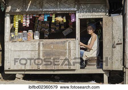"Woman selling goods in a wooden shack in the outskirts of Sibsagar, Sibsagarh, India, Asia" View Large Photo Image Stock Photo - "Woman selling goods in a wooden shack in the outskirts of Sibsagar, Sibsagarh, India, Asia". Fotosearch