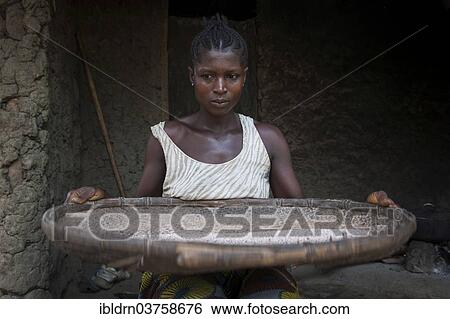 "Woman separating grain from the chaff outside a hut, Tiwai Island, Southern Province, Sierra Leone, Africa" View Large Photo Image Stock Photograph - "Woman separating grain from the chaff outside a hut, Tiwai Island, Southern Province, Sierra Leone, Africa". Fotosearch