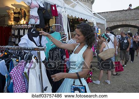 Stock Photograph - "Woman shopping at the Summer Jamboree Rock'n'Roll Festival, historic center, Senigallia, Province of Ancona, Italy, Europe". Fotosearch