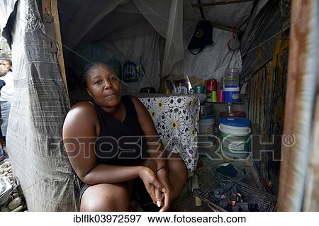 "Woman sitting at the entrance to their temporary dwelling, Camp Icare, camp for earthquake refugees, Fort National, Port-au-Prince, Haiti, North America" View Large Photo Image Stock Photo - "Woman sitting at the entrance to their temporary dwelling, Camp Icare, camp for earthquake refugees, Fort National, Port-au-Prince, Haiti, North America". Fotosearch