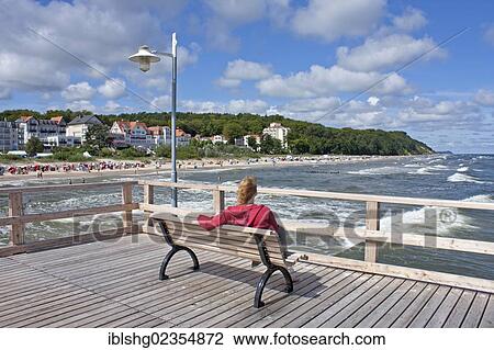 "Woman sitting on a bench, pier, Bansin, Usedom Island, Mecklenburg-Western Pomerania, Germany, Europe" View Large Photo Image Stock Image - "Woman sitting on a bench, pier, Bansin, Usedom Island, Mecklenburg-Western Pomerania, Germany, Europe". Fotosearch