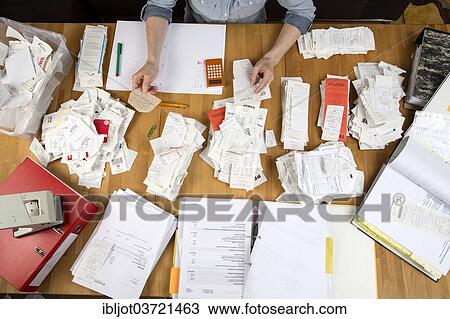 "Woman sorting documents, records, invoices and receipts on a desk, for the tax return" View Large Photo Image Stock Image - "Woman sorting documents, records, invoices and receipts on a desk, for the tax return". Fotosearch