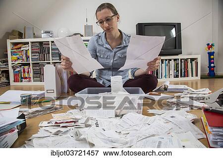"Woman sorting documents, records, invoices and receipts on the ground, for the tax return" View Large Photo Image Stock Photo - "Woman sorting documents, records, invoices and receipts on the ground, for the tax return". Fotosearch