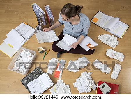 "Woman sorting documents, records, invoices and receipts on the ground, for the tax return" View Large Photo Image Stock Photograph - "Woman sorting documents, records, invoices and receipts on the ground, for the tax return". Fotosearch