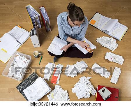 "Woman sorting documents, records, invoices and receipts on the ground, for the tax return" View Large Photo Image Stock Photography - "Woman sorting documents, records, invoices and receipts on the ground, for the tax return". Fotosearch