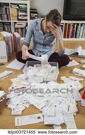 "Woman sorting documents, records, invoices and receipts on the ground, for the tax return" View Large Photo Image Stock Photography - "Woman sorting documents, records, invoices and receipts on the ground, for the tax return". Fotosearch