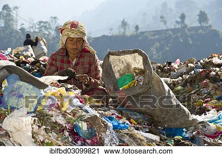 "Woman sorting out garbage at Aletar garbage dump, earning 300-400 nepali rupees a day, Aletar, Kathmandu District, Bagmati Zone, Nepal, Asia" View Large Photo Image Stock Image - "Woman sorting out garbage at Aletar garbage dump, earning 300-400 nepali rupees a day, Aletar, Kathmandu District, Bagmati Zone, Nepal, Asia". Fotosearch