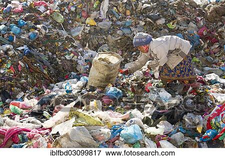 "Woman sorting out garbage at Aletar garbage dump, earning 300-400 nepali rupees a day, Aletar, Kathmandu District, Bagmati Zone, Nepal, Asia" View Large Photo Image Stock Photo - "Woman sorting out garbage at Aletar garbage dump, earning 300-400 nepali rupees a day, Aletar, Kathmandu District, Bagmati Zone, Nepal, Asia". Fotosearch