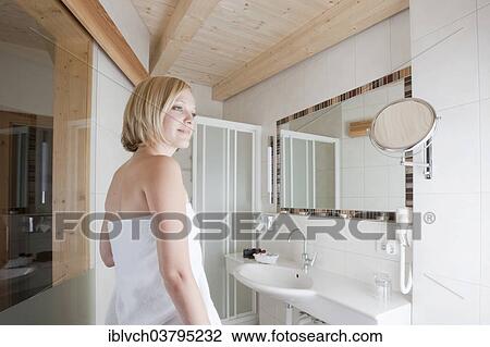 Woman standing in a bathroom View Large Photo Image Stock Image - Woman standing in a bathroom. Fotosearch