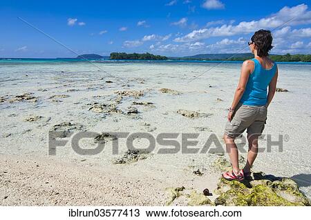 "Woman standing on the beach looking towards the sea, Port Orly, Espiritu Santo, Sanma Province, Vanuatu, Oceania" View Large Photo Image Stock Image - "Woman standing on the beach looking towards the sea, Port Orly, Espiritu Santo, Sanma Province, Vanuatu, Oceania". Fotosearch