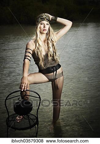 "Woman standing with a chair in the water, fashion, Lake Achen, Maurach, Tyrol, Austria, Europe" View Large Photo Image Stock Photo - "Woman standing with a chair in the water, fashion, Lake Achen, Maurach, Tyrol, Austria, Europe". Fotosearch