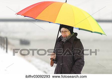 "Woman standing with a colourful umbrella in winter on the bank of the Rhine River, Dusseldorf, Rhineland, North Rhine-Westphalia, Germany, Europe" View Large Photo Image Stock Image - "Woman standing with a colourful umbrella in winter on the bank of the Rhine River, Dusseldorf, Rhineland, North Rhine-Westphalia, Germany, Europe". Fotosearch