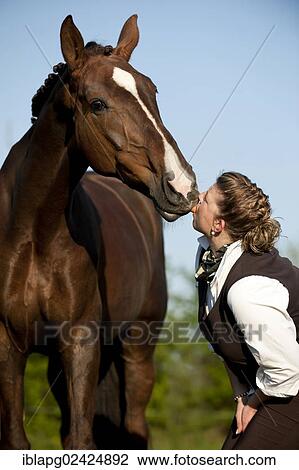 Woman standing with an Oldenburg horse View Large Photo Image Stock Image - Woman standing with an Oldenburg horse. Fotosearch