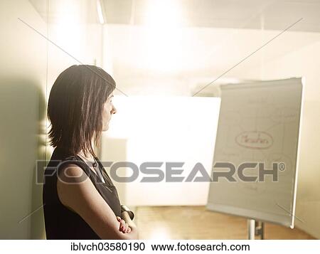 "Woman standing with her arms crossed in an office, looking at a flip chart, Innsbruck, Tyrol, Austria, Europe" View Large Photo Image Stock Image - "Woman standing with her arms crossed in an office, looking at a flip chart, Innsbruck, Tyrol, Austria, Europe". Fotosearch