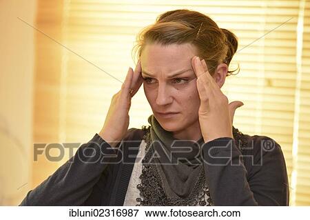Stock Photo - Woman suffering a headache. Fotosearch