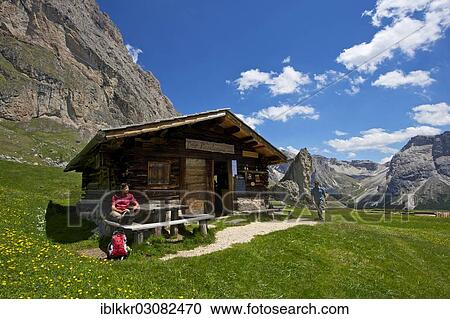 "Woman taking a break on the Malga Alm alpine pasture below the Odle Mountains, Seceda Mountain, Grodnertal, Dolomiten, South Tyrol province, Trentino-Alto Adige, Italy, Europe" View Large Photo Image Stock Image - "Woman taking a break on the Malga Alm alpine pasture below the Odle Mountains, Seceda Mountain, Grodnertal, Dolomiten, South Tyrol province, Trentino-Alto Adige, Italy, Europe". Fotosearch