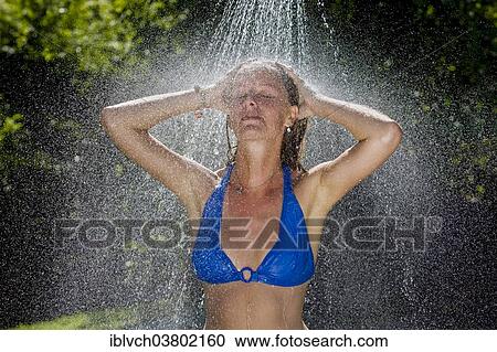 "Woman taking a shower outdoors, Tyrol, Austria, Europe" View Large Photo Image Stock Image - "Woman taking a shower outdoors, Tyrol, Austria, Europe". Fotosearch