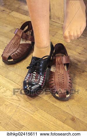 Woman trying on shoes, modern and old-fashioned, wearing try-on stockings View Large Photo Image Stock Image - Woman trying on shoes, modern and old-fashioned, wearing try-on stockings. Fotosearch