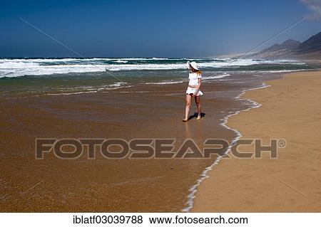 "Woman walking along a sandy beach, Morro Jable, Naturpark Jandia, Fuerteventura, Canary Islands, Spain, Europe" View Large Photo Image Stock Photo - "Woman walking along a sandy beach, Morro Jable, Naturpark Jandia, Fuerteventura, Canary Islands, Spain, Europe". Fotosearch
