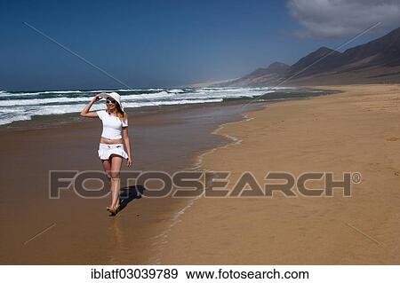 "Woman walking along a sandy beach, Morro Jable, Naturpark Jandia, Fuerteventura, Canary Islands, Spain, Europe" View Large Photo Image Stock Photo - "Woman walking along a sandy beach, Morro Jable, Naturpark Jandia, Fuerteventura, Canary Islands, Spain, Europe". Fotosearch