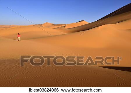 "Woman walking in the dunes of In Tehak, Tadrart region, Tassili n'Ajjer National Park, Unesco World Heritage Site, Algeria, Sahara, North Africa, Africa" View Large Photo Image Stock Photograph - "Woman walking in the dunes of In Tehak, Tadrart region, Tassili n'Ajjer National Park, Unesco World Heritage Site, Algeria, Sahara, North Africa, Africa". Fotosearch