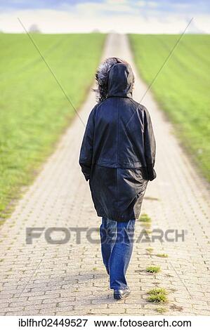 "Woman walking on a field path, from behind, Grevenbroich, North Rhine-Westphalia, Germany, Europe" View Large Photo Image Stock Photo - "Woman walking on a field path, from behind, Grevenbroich, North Rhine-Westphalia, Germany, Europe". Fotosearch