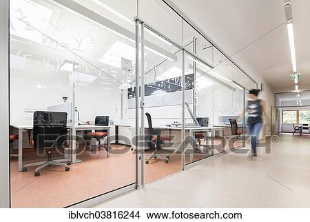 "Woman walking past a middle school's teacher's offices, Reith im Alpbachtal, Tyrol, Austria, Europe" View Large Photo Image Picture - "Woman walking past a middle school's teacher's offices, Reith im Alpbachtal, Tyrol, Austria, Europe". Fotosearch