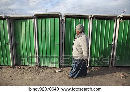 "Woman walking past toilets in Khayelitsha, South Africa, Africa" View Large Photo Image Stock Image - "Woman walking past toilets in Khayelitsha, South Africa, Africa". Fotosearch
